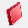 A red baking dish with a frame is shown at an angle against a light gray background. Produktbild-Vorschau