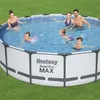 A family is enjoying a day in an above-ground swimming pool on a grassy lawn. Produktbild-Vorschau