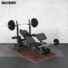 A weight bench with barbells and weights on a wooden mat in front of a white brick wall. Náhľad obrázku produktu