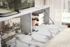 A modern TV stand with marble-like finish, featuring open compartments with books and a record player. Produktbild-Vorschau