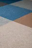 A close-up view of carpet tiles with a geometric pattern. Produktbild-Vorschau