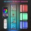 A tall, narrow glass display cabinet with internal LED lighting, shown with a smartphone app interface and a remote control, and three inset images demonstrating different LED color options. Produktbild-Vorschau