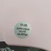 A sticker on a pink surface with product information. Anteprima dell’immagine prodotto