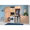A laundry room setup with a washing machine, storage cabinets, and laundry baskets. Produktbild-Vorschau