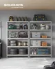 Two metal shelving units filled with various tools and storage containers in a garage or workshop setting. Produktbild-Vorschau