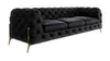 A black Chesterfield sofa with gold metal legs, shown from a side-angle on a white background. Produktbild-Vorschau