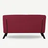 The back view of a red sofa with black legs and zippers on the sides. Náhled obrázku produktu