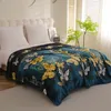A blanket with a butterfly pattern is laid out on a bed. Produktbild-Vorschau