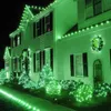 A house decorated with green Christmas lights at night. Produktbild-Vorschau