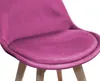 Close-up of a pink velvet chair seat and wooden legs. Produktbild-Vorschau