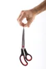 A hand holding a pair of scissors. Náhľad obrázku produktu