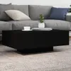 A black coffee table sits in front of a gray sofa on a gray carpet. Produktbild-Vorschau