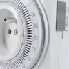 A close-up view of a white electrical timer switch with a dial and a gray lever. Náhľad obrázku produktu