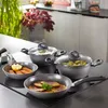 A set of cookware is displayed on a stovetop, with food items in some of the pots and pans. Produktbild-Vorschau