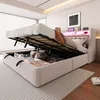 A bed with its storage compartment open, revealing stored items. The bed has a headboard with LED lighting. Náhled obrázku produktu