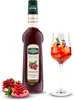 A bottle of Mathieu Teisseire Grenadine syrup, two pomegranate halves, and a glass of cocktail. Produktbild-Vorschau