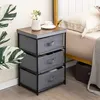 A bedside table with fabric drawers next to a bed. Podgląd zdjęcia produktu