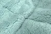 A close-up, textured view of a soft, fluffy fabric in a menthol green color. Náhľad obrázku produktu