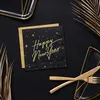 A New Year's Eve table setting with black and gold themed napkins, plates, and cutlery, accented with dried palm leaves. Produktbild-Vorschau