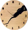 A close-up view of a wooden wall clock with a black abstract design. Anteprima dell’immagine prodotto