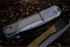 A close-up of a folding saw and its protective sheath lying on the ground. Produktbild-Vorschau