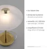 A close-up of a table lamp with descriptive text on the right side. Voir les images du produit