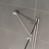 A close-up view of a shower door hinge mechanism attached to a tiled wall. Produktbild-Vorschau