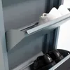 A close-up view of a gray metal shoe cabinet with two shelves, each holding a pair of shoes. Voir les images du produit