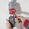 A person is using a Voltcraft VC-32 phase rotation tester to check an electrical outlet. Produktbild-Vorschau