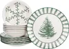A stack of white plates and bowls with green Christmas-themed designs. Produktbild-Vorschau