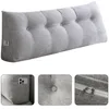 A long, wedge-shaped pillow with button tufting and side pockets, shown against a white background. Produktbild-Vorschau