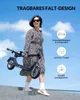 A woman is holding a folded electric scooter while standing on a set of stairs with a blue sky and clouds in the background. Produktbild-Vorschau