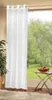 A white sheer curtain hangs in front of a window with a view of trees and grass. A small table with fruit is to the right. Produktbild-Vorschau