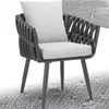 A close-up view of a modern outdoor chair with a woven frame and light-colored cushions. Produktbild-Vorschau