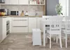 A clean, modern kitchen with white cabinets and a dining set. Produktbild-Vorschau
