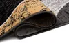 A close-up view of a rolled-up rug, showing the texture and pattern of the material. Anteprima dell’immagine prodotto