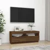 A TV stand with a TV mounted above it, in a living room setting. Náhled obrázku produktu