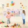 Two young children interacting with a large, colorful activity wall in a room. Produktbild-Vorschau