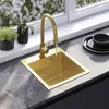 A modern kitchen sink with a gold faucet, set against a window with blooming flowers. Podgląd zdjęcia produktu