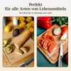 A split image showing a cutting board with bread and avocado on the left, and a cutting board with tomatoes, onion, and bell pepper on the right. Produktbild-Vorschau