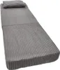 A folded grey mattress with a pillow on a white background. Voir les images du produit