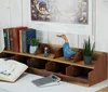 A wooden desk organizer with books, a plant, and a decorative duck. Náhled obrázku produktu