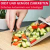 A person is using a vegetable scoop to collect chopped vegetables from a cutting board. Produktbild-Vorschau