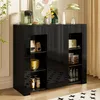 A black sideboard cabinet with open shelves displaying various items, including food packaging, bowls, a toaster, and bottles. Náhled obrázku produktu