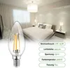 A bedroom scene with a bed and bedside tables, with a close-up of an LED light bulb in the foreground. Produktbild-Vorschau