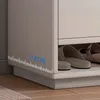 Close up of a shoe rack with shoes inside, with a ruler marking measurements on the side. Náhľad obrázku produktu