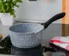 A speckled gray saucepan with a black handle sits on a black induction stovetop, next to a potted plant and a red and white checkered towel. Náhľad obrázku produktu