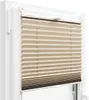 A close-up view of a beige pleated blind installed in a white window frame. Anteprima dell’immagine prodotto