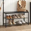 A shoe rack with shoes and a backpack on top, next to a wall. Produktbild-Vorschau