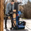 A man is using a wood splitter outdoors in a yard. Produktbild-Vorschau